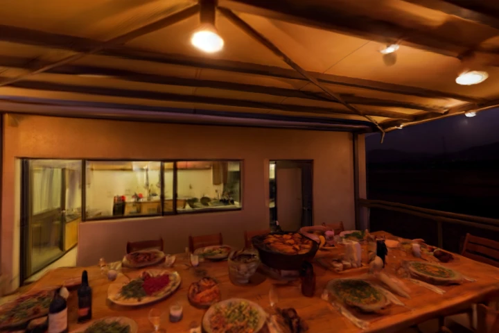 Communal dinner on the terrace at dusk